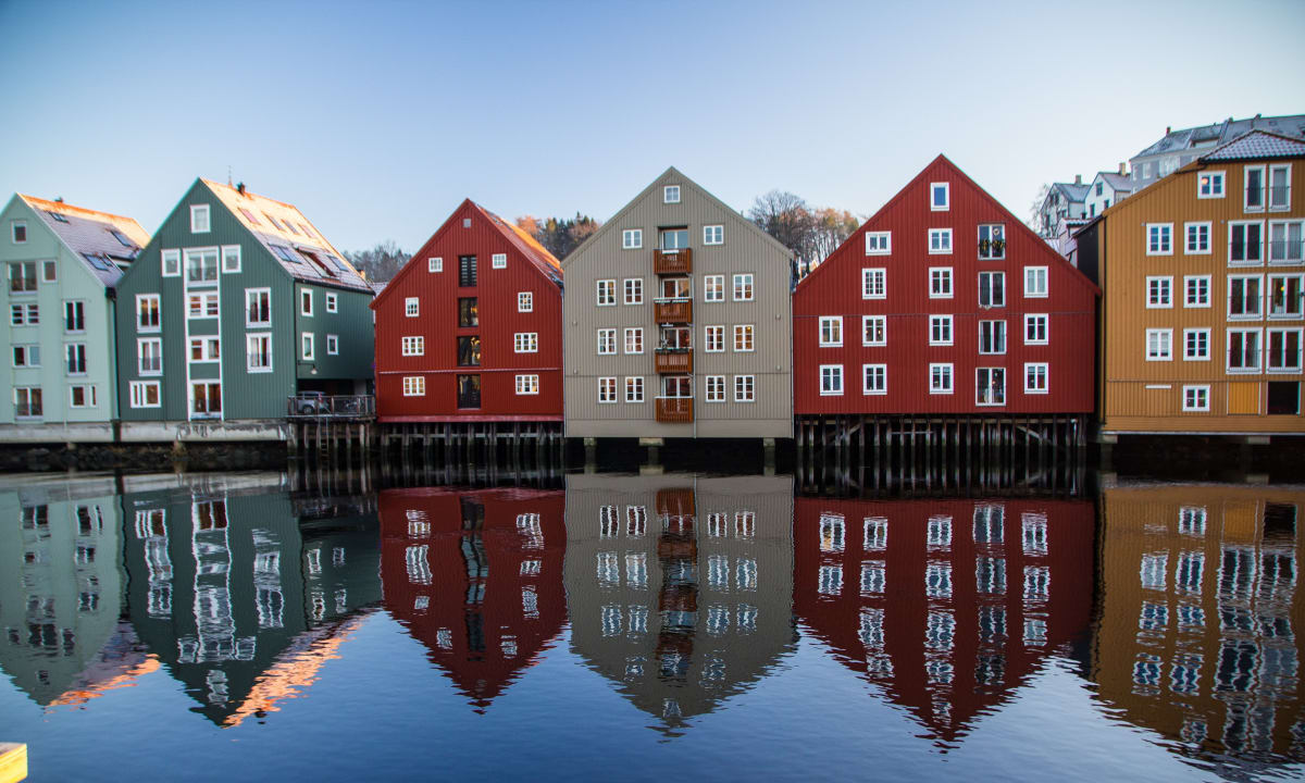 Photo of colorful houses on the river in Trondheim, Norway by Simon Williams on Unsplash