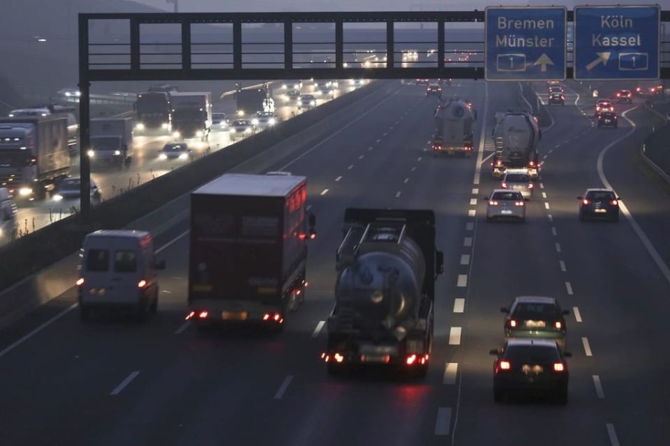 Freight trucks on a highway at dusk