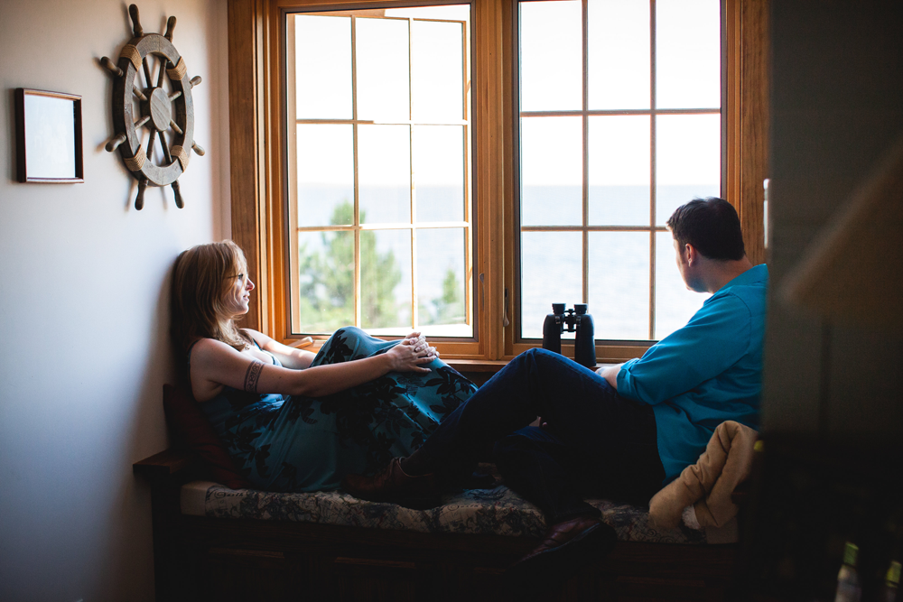 Sally and Ryan sitting in a window seat looking out across Lake Superior