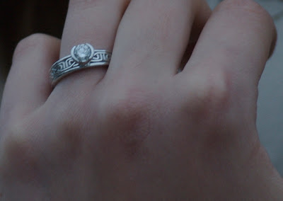 Close-up of Sally's engagement ring, white gold with a diamond and a Celtic knot pattern