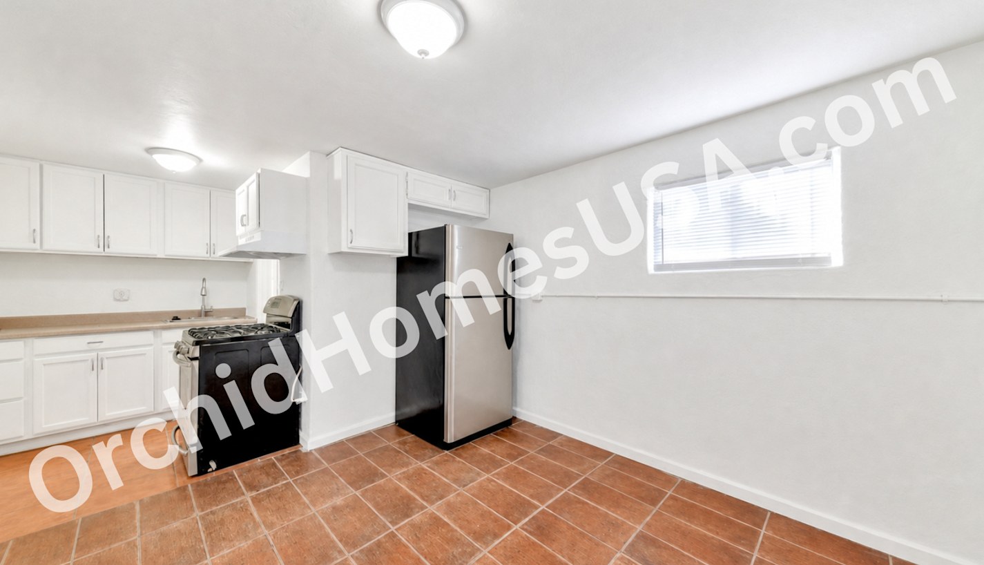 Studio kitchen and living area — apartment 6 at 909 South 35th Apartments.