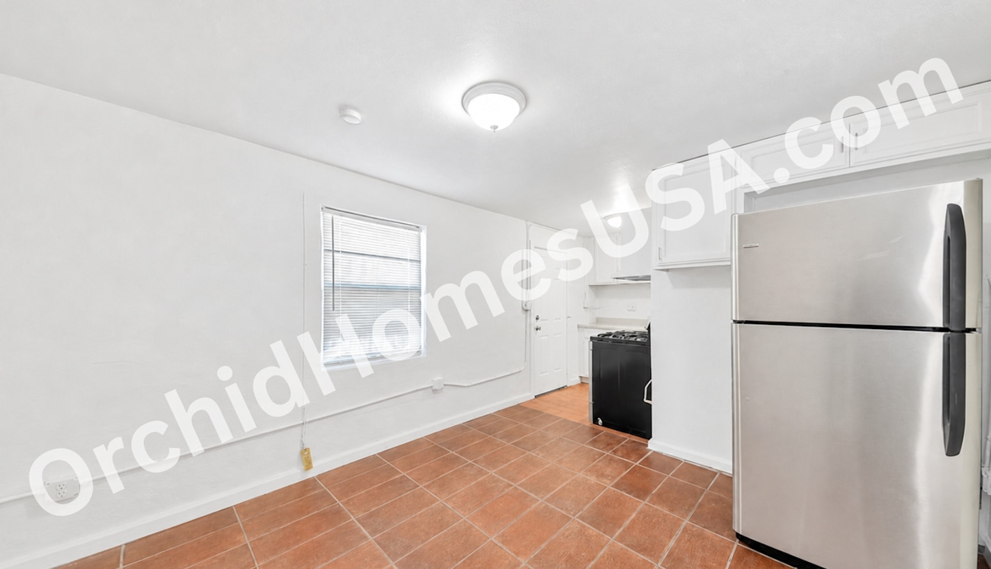 Studio kitchen and living area — apartment 6 at 909 South 35th Apartments.