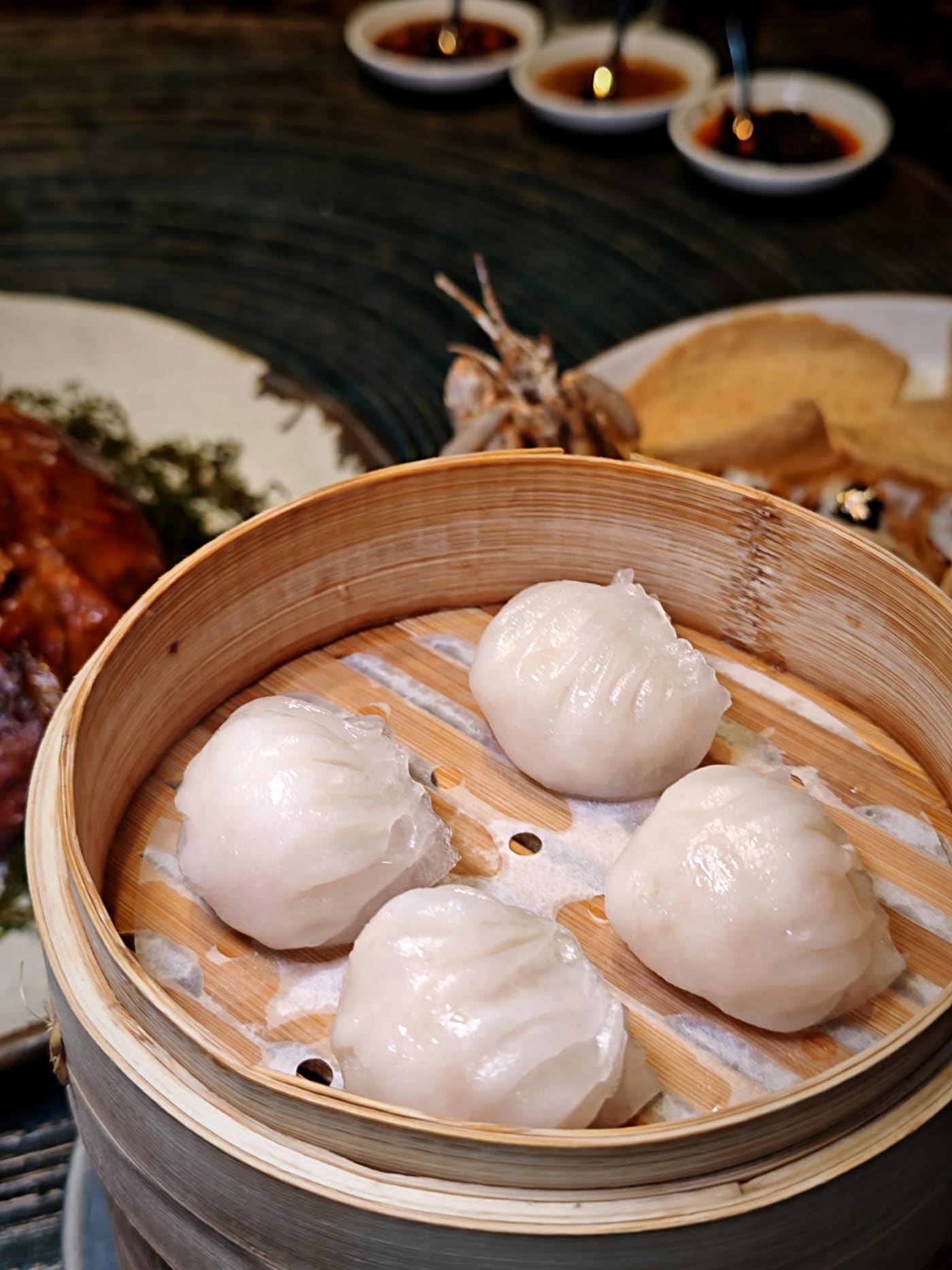 The dim sum lineup is stellar across the board — crispy shrimp rice noodle rolls, deep-fried tofu-skin shrimp rolls, thin-skinned har gow, and shumai topped with shrimp roe. And the 42-day apple-wood-roasted Peking duck — glossy, crackling skin over tender, juicy meat — is the signature dish you have to order. We'd recommend pre-ordering at least 24 hours ahead since it's limited per day (one duck feeds 3–4 people).