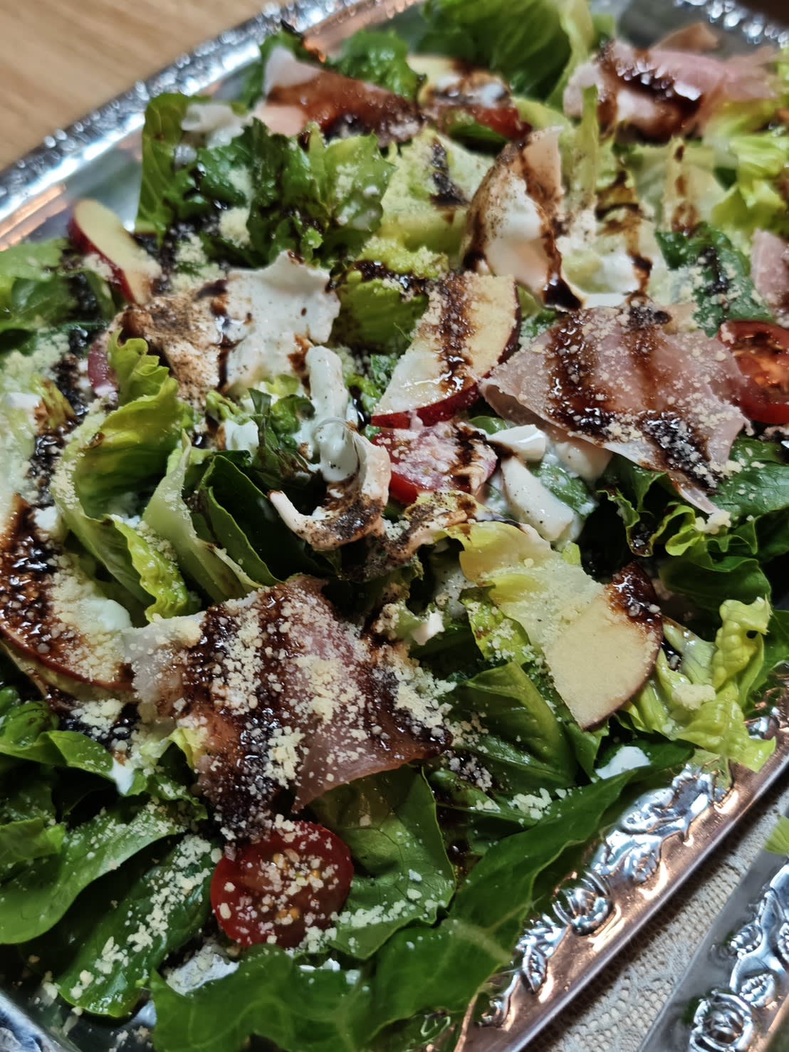 Smoked ham with salad greens and tomato, drizzled with balsamic glaze. The clever part: burrata cheese is whipped right into the sauce, so you get a silky, creamy richness — you don't even need to see a chunk of cheese to know it's loaded.