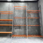 empty cantilever racking against warehouse wall