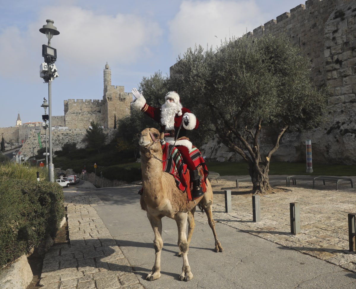 עיסא אניס קסיסיה מחופש לסנטה קלאוס בירושלים העתיקה / צילום: Associated Press, Mahmoud Illean