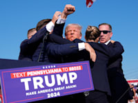 טראמפ מוקף במאבטחים ומנופף באגרוף לאחר הירי, לפני שפונה מהמקום / צילום: Associated Press, Evan Vucci