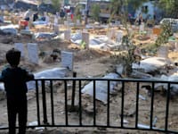 ילד משקיף על בית קברות מאולתר בעיר עזה. התקשורת העלימה האמת / צילום: ap, Mohammed Hajjar