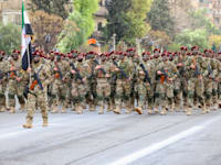 מצעד צבאי לציון יום השנה הראשון לחילוף משטר אסד / צילום: Reuters, Mohammad Daher/NurPhoto