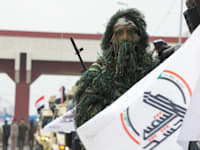 חייל חשד א–שעבי באירוע לציון הניצחון על דאע''ש בבגדד / צילום: Reuters, Ahmed Saad