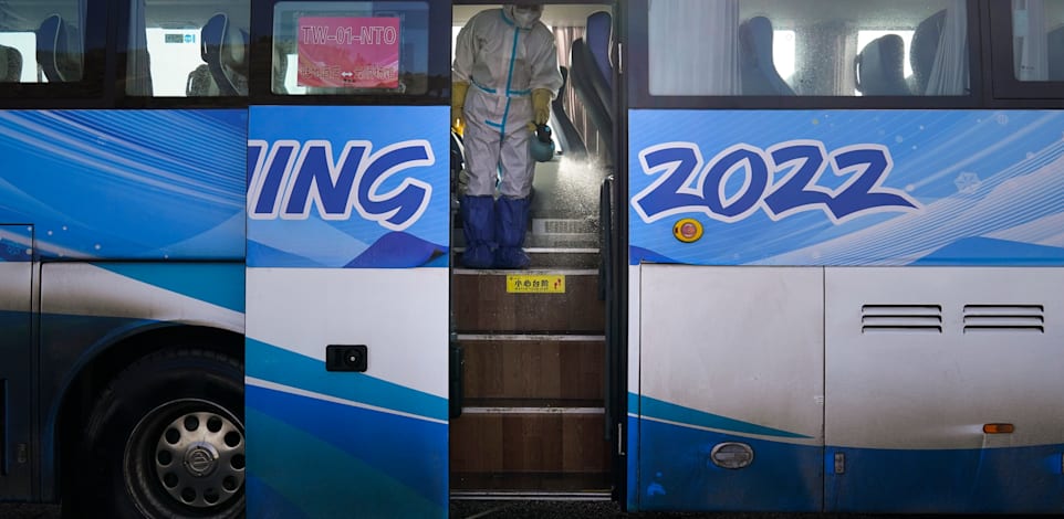 עובד מחטא אוטובוס לקראת אולימפיאדת החורף בבייג'ינג / צילום: Associated Press, Jae C. Hong