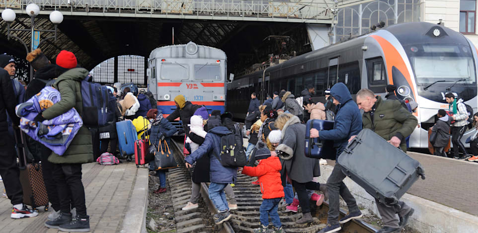 אנשים מחכים לרכבת בלביב כדי לעזוב את אוקראינה / צילום: Associated Press, Mykola Tys