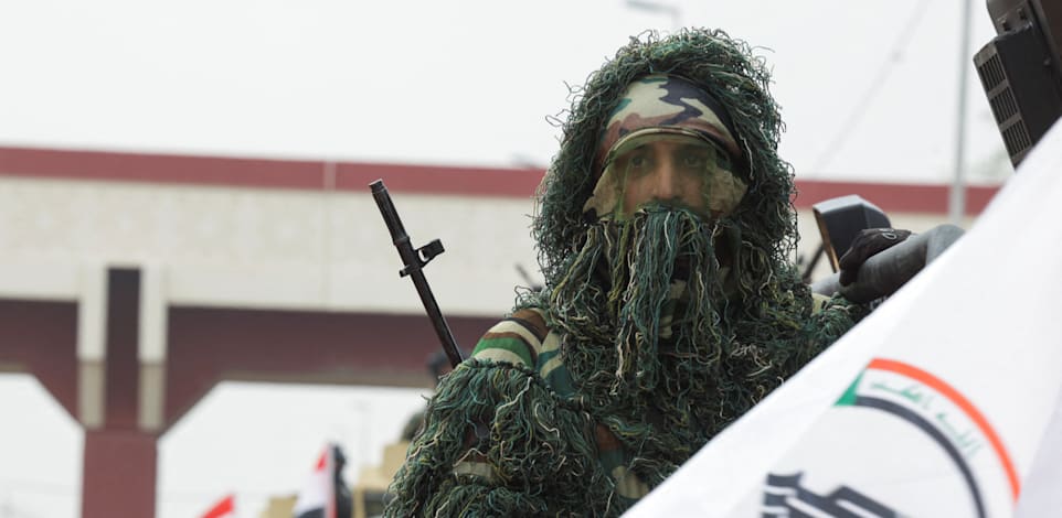 חייל חשד א–שעבי באירוע לציון הניצחון על דאע''ש בבגדד / צילום: Reuters, Ahmed Saad