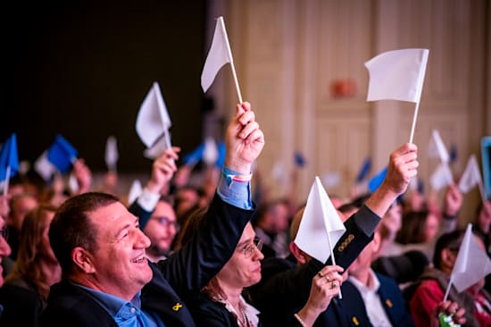 קהל הוועידה מצביע באמצעות דגלים לשאלות מהבמה / צילום: יוסי כהן