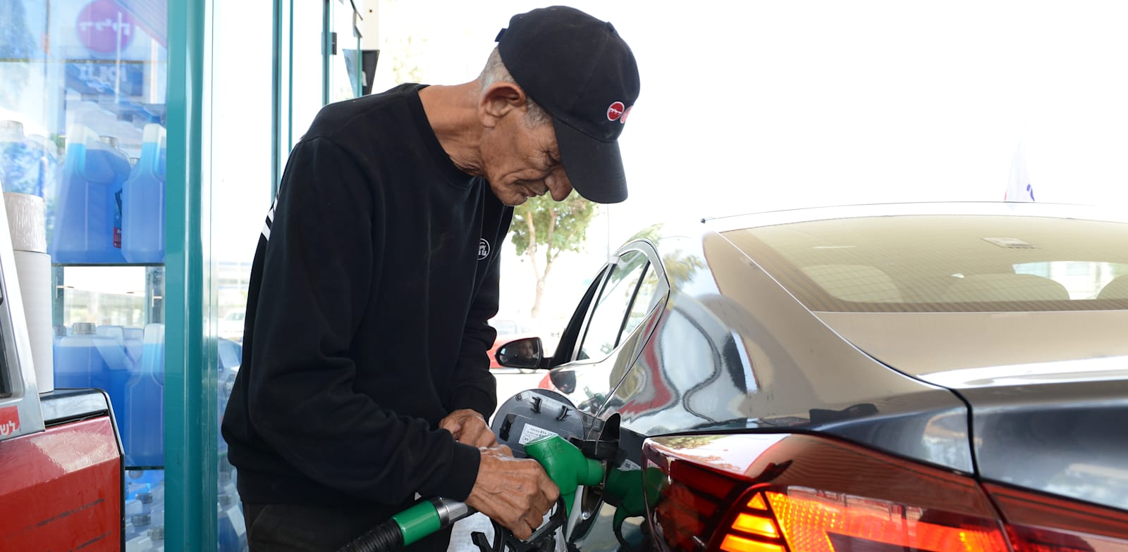 Gas pump attendant credit: Eyal Izhar