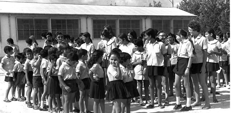 "תלמידי כיתה ח' מקבלים את פניהם של תלמידי כיתה א' ביום הראשון ללימודים, לוד, 1970 / צילום: MILNER MOSHE"