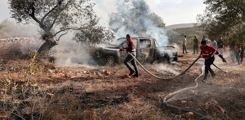 Vehilce set alight by rioters on West Bank  credit: Reuters/Ammar Awad