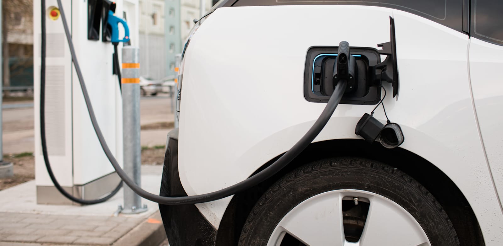 Electric car at charging station credit: Shutterstock