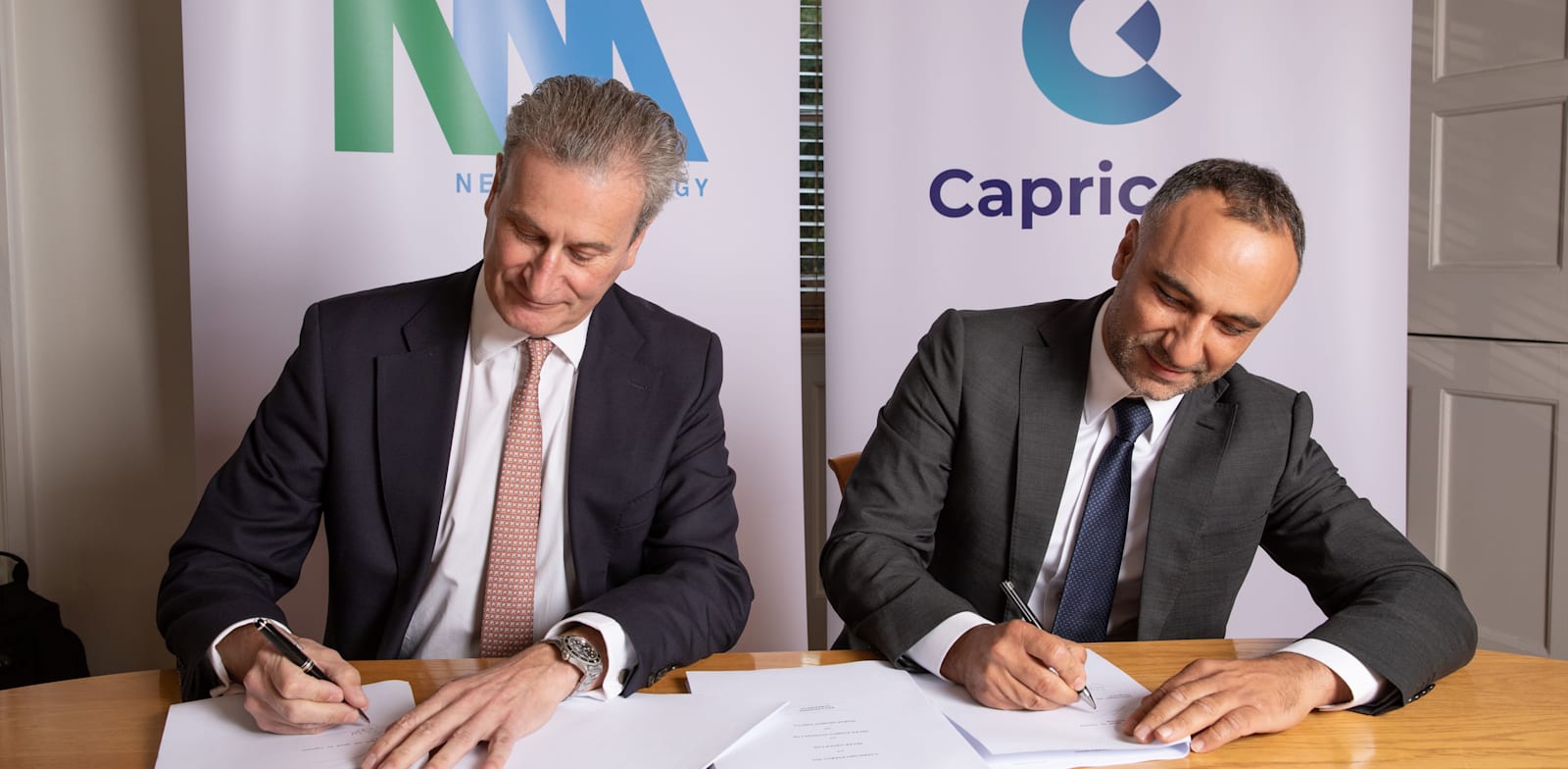 NewMed Energy CEO Yossi Abu signs merger with Capricorn CEO Simon Thomson credit: NewMed Energy