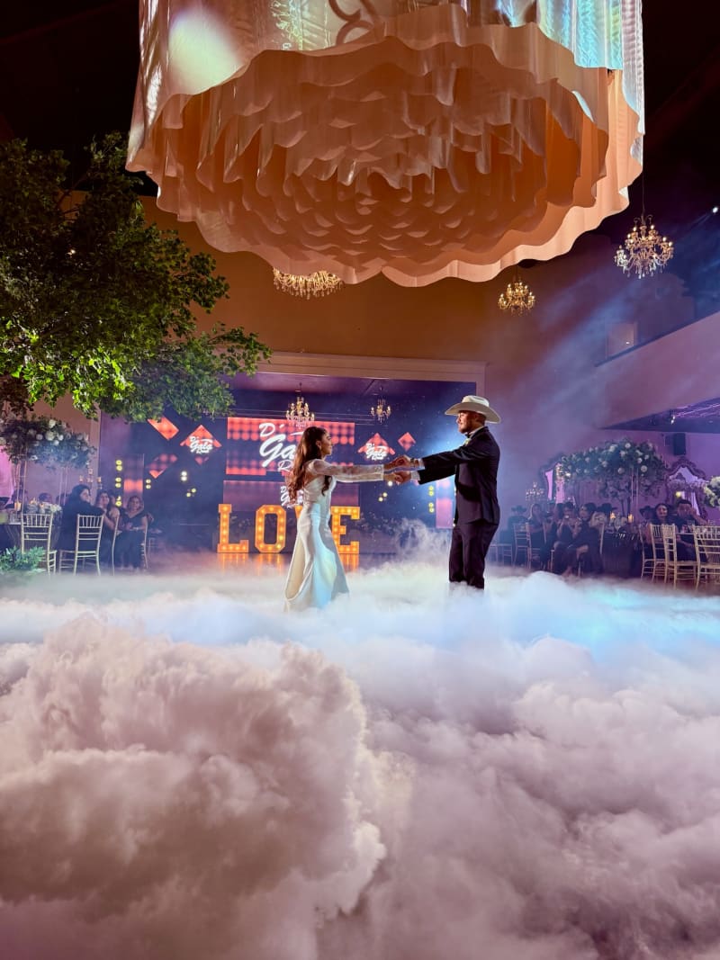 Couple dancing through low-lying clouds