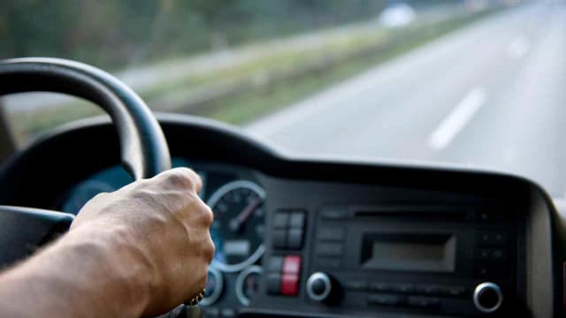 a CDL holder driving a truck on a road