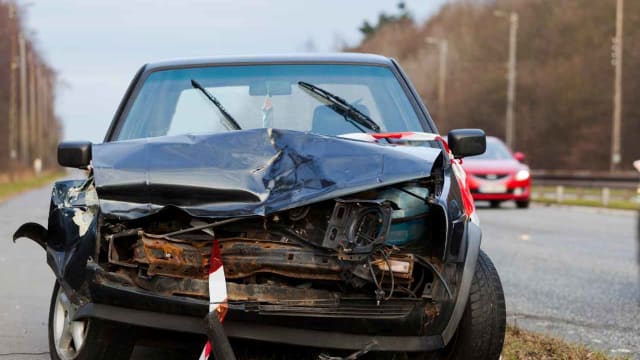 a car on the side of the road damaged from an accident