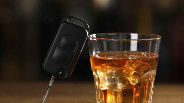car keys and alcohol on a bar top