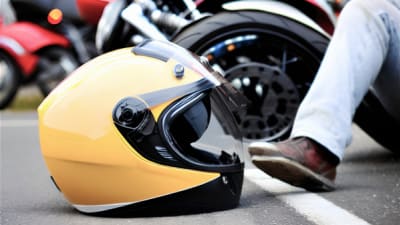 a motorcycle helmet on the ground due to a motorcycle accident