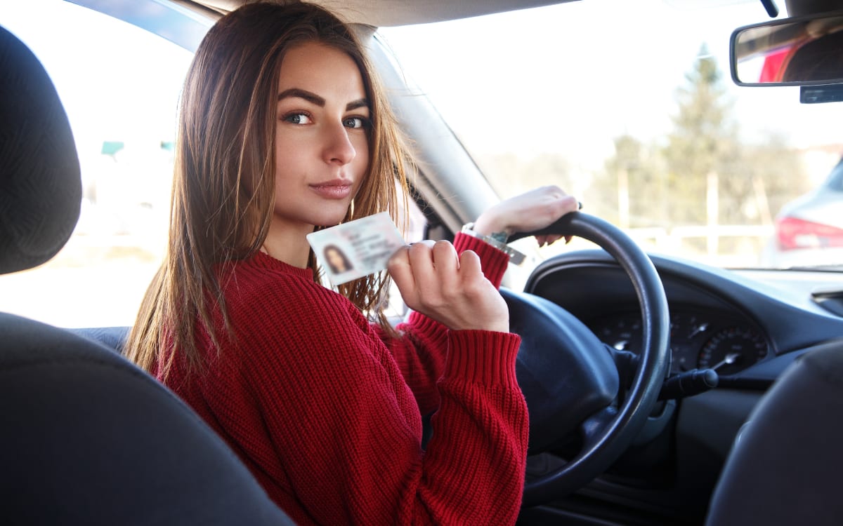 woman showing that she got her driver's license back