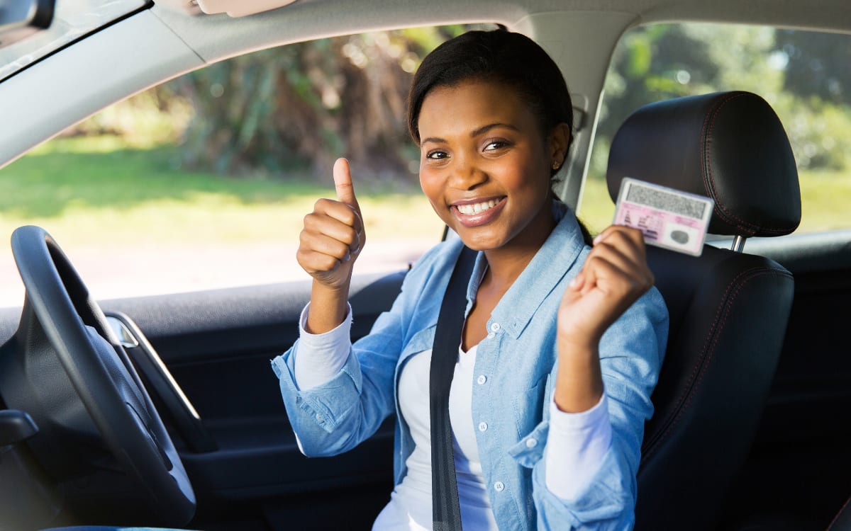 woman showing that she got her driver's license back