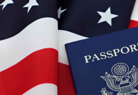 a US passport on an American flag
