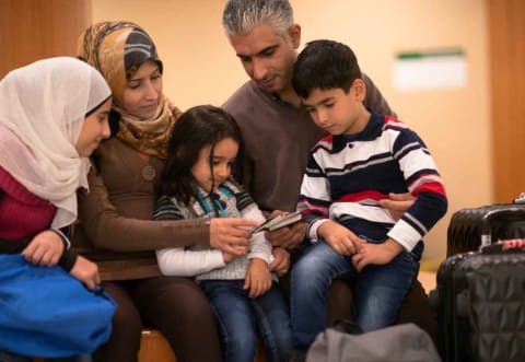 a family looking over an immigration visa