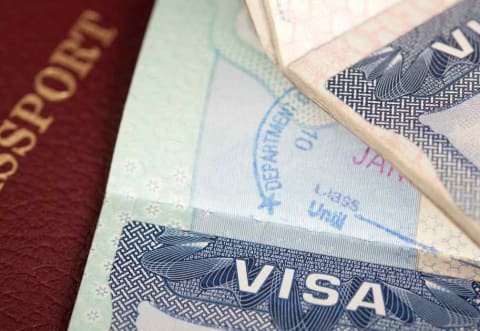 a closeup photo of a visa and passport