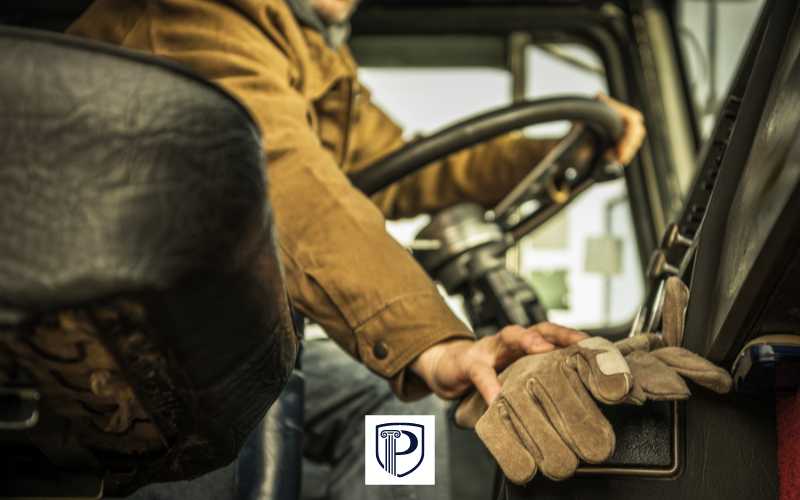 a man in the cab of a commercial truck