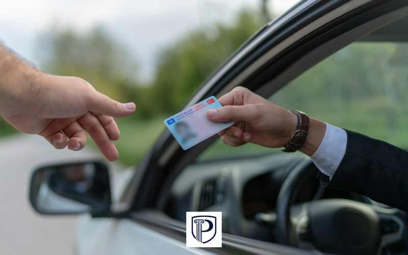a man handing a police officer his drivers license after being pulled over