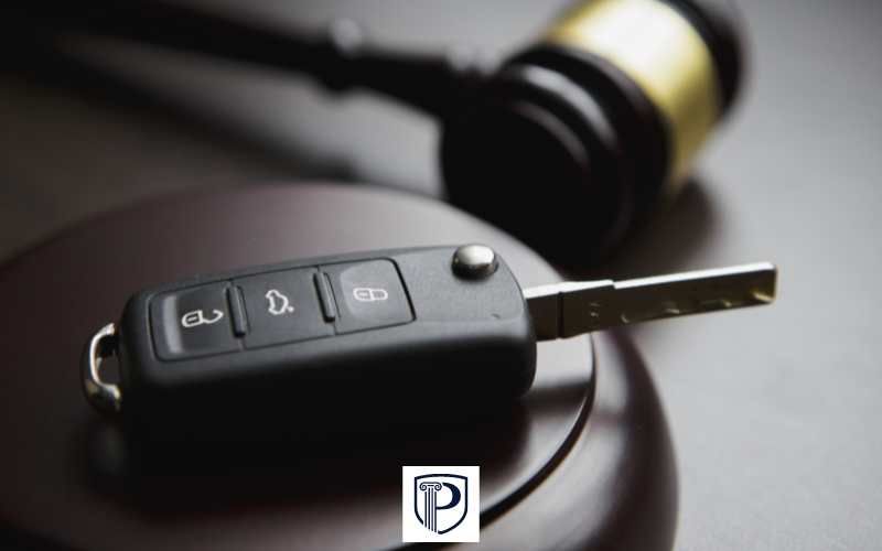 a gavel and car key on a desk
