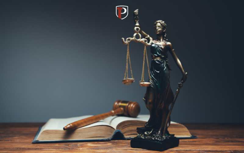 a legal book and small statue of justice on a desk