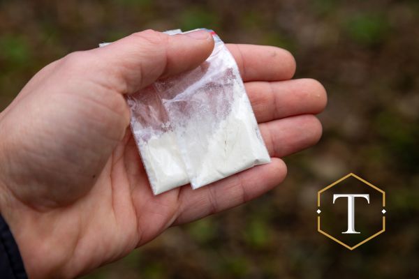 someone holding two baggies of cocaine