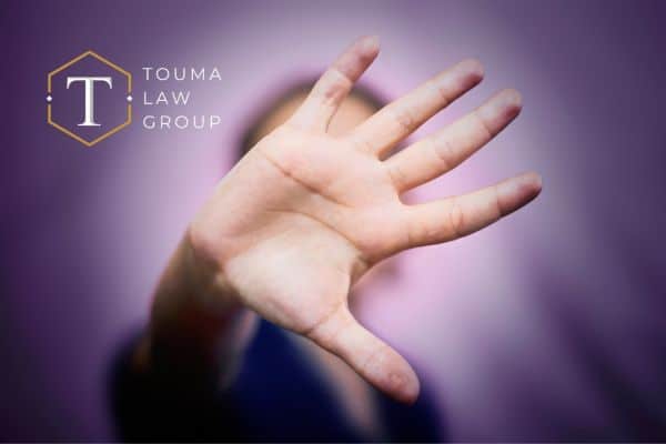 a person holding their hand up to stop domestic violence