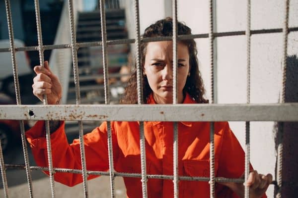 teenage girl in jail behind bars, Teenager was Charged with a Crime