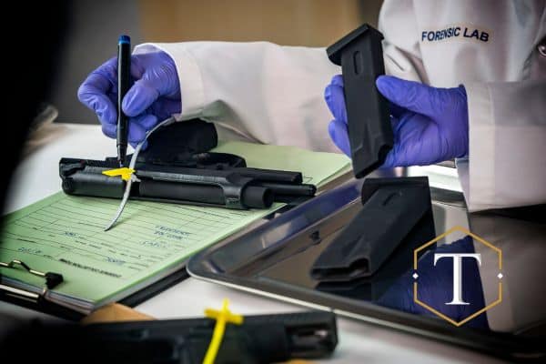 a forensic scientist examining a gun