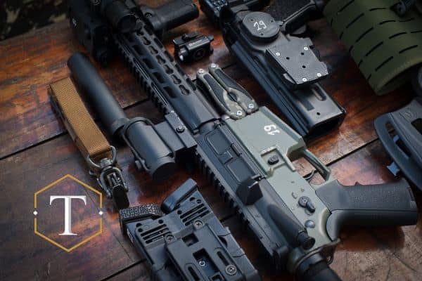 an assault rifle next to attachments and pieces