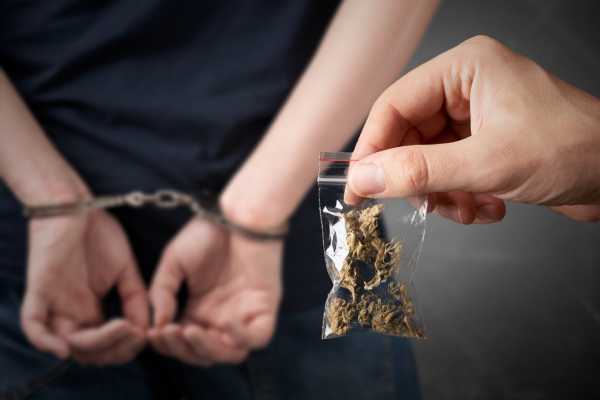 a man being arrested for marijuana possession