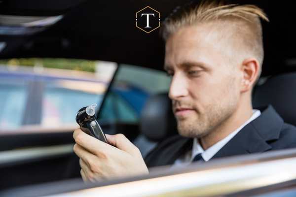 a man holding an ignition interlock device