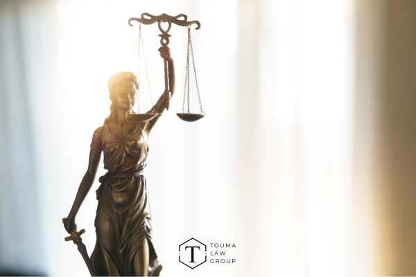 a photo of the statue of justice on a desk in front of a window