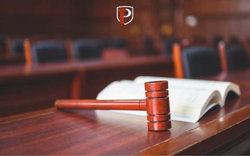 a gavel and legal book on a table in a court room