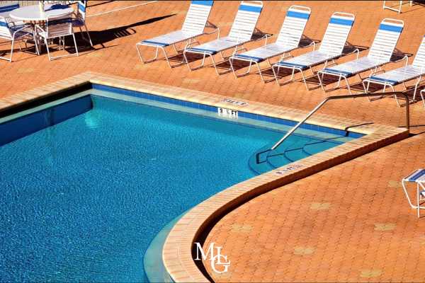 chairs next to a public pool