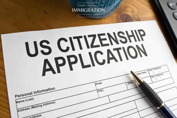 an application for citizenship on a desk with a pen