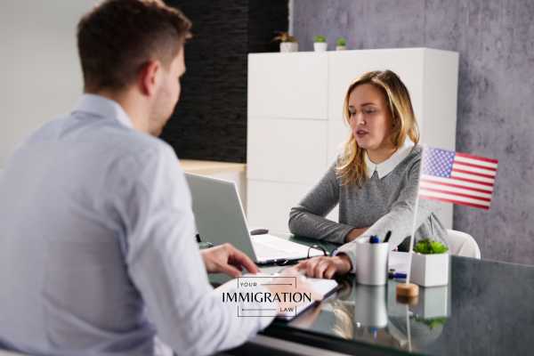 a man meeting with USCIS regarding his h-1b visa status