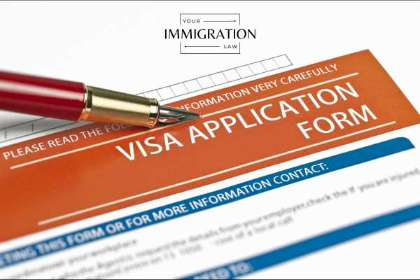 a pen and application form for a j1 visa